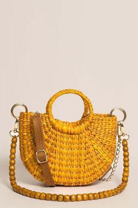 Yellow woven handbag with a chain detail on a beige background. Orange Inca The New Mini Fiesta Bag Yellow