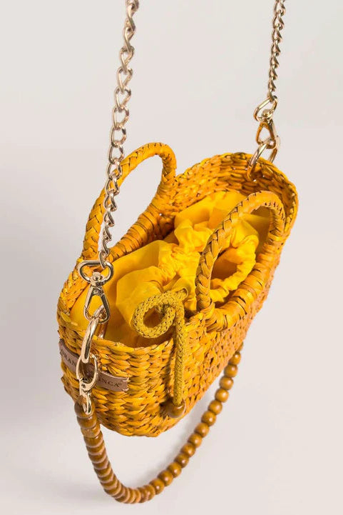 Yellow woven handbag with a chain strap on a light gray background. Orange Inca The New Mini Fiesta Bag Yellow