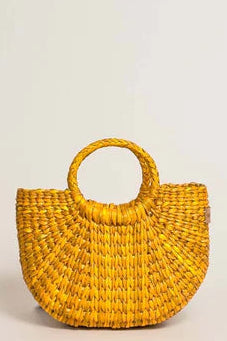 Yellow woven handbag on a light beige background. Orange Inca The New Mini Fiesta Bag Yellow