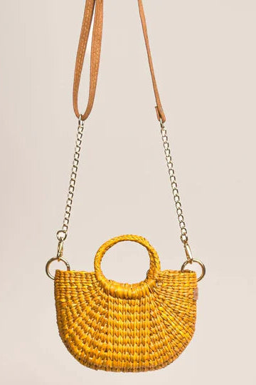 Yellow woven handbag with a chain strap on a beige background. Orange Inca The New Mini Fiesta Bag Yellow