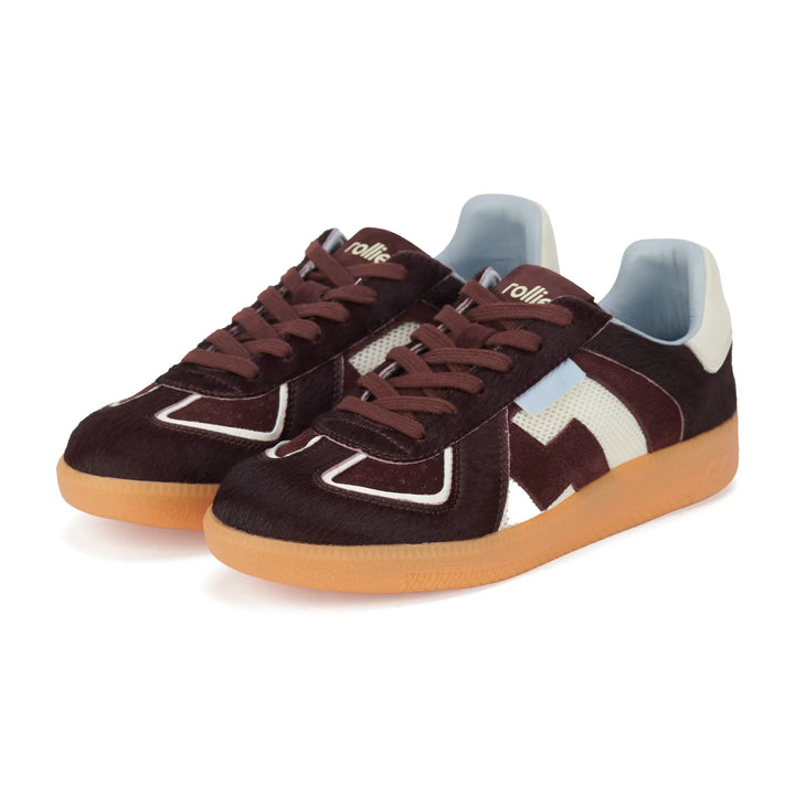 Pair of brown sneakers with white and blue accents on a white background