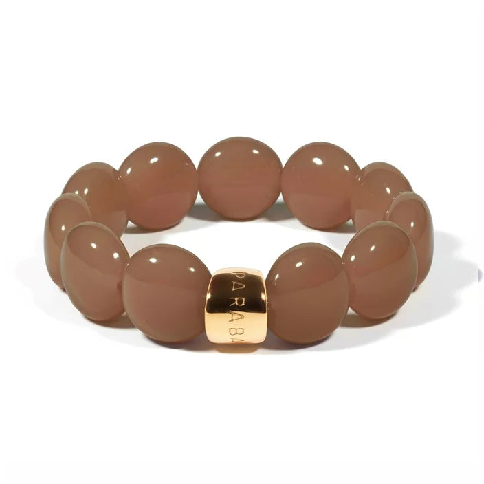 Brown beaded bracelet with a gold tag on a white background