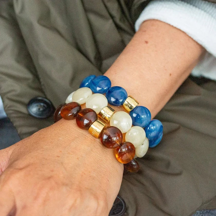 Multicolored beaded bracelet on a wrist with a blurred background