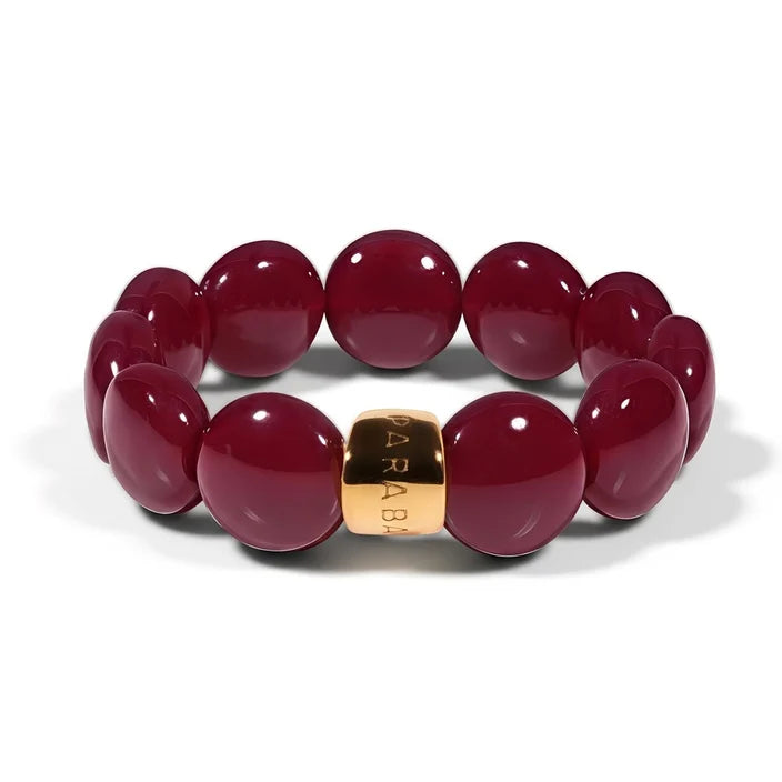 Red beaded bracelet with a gold clasp on a white background