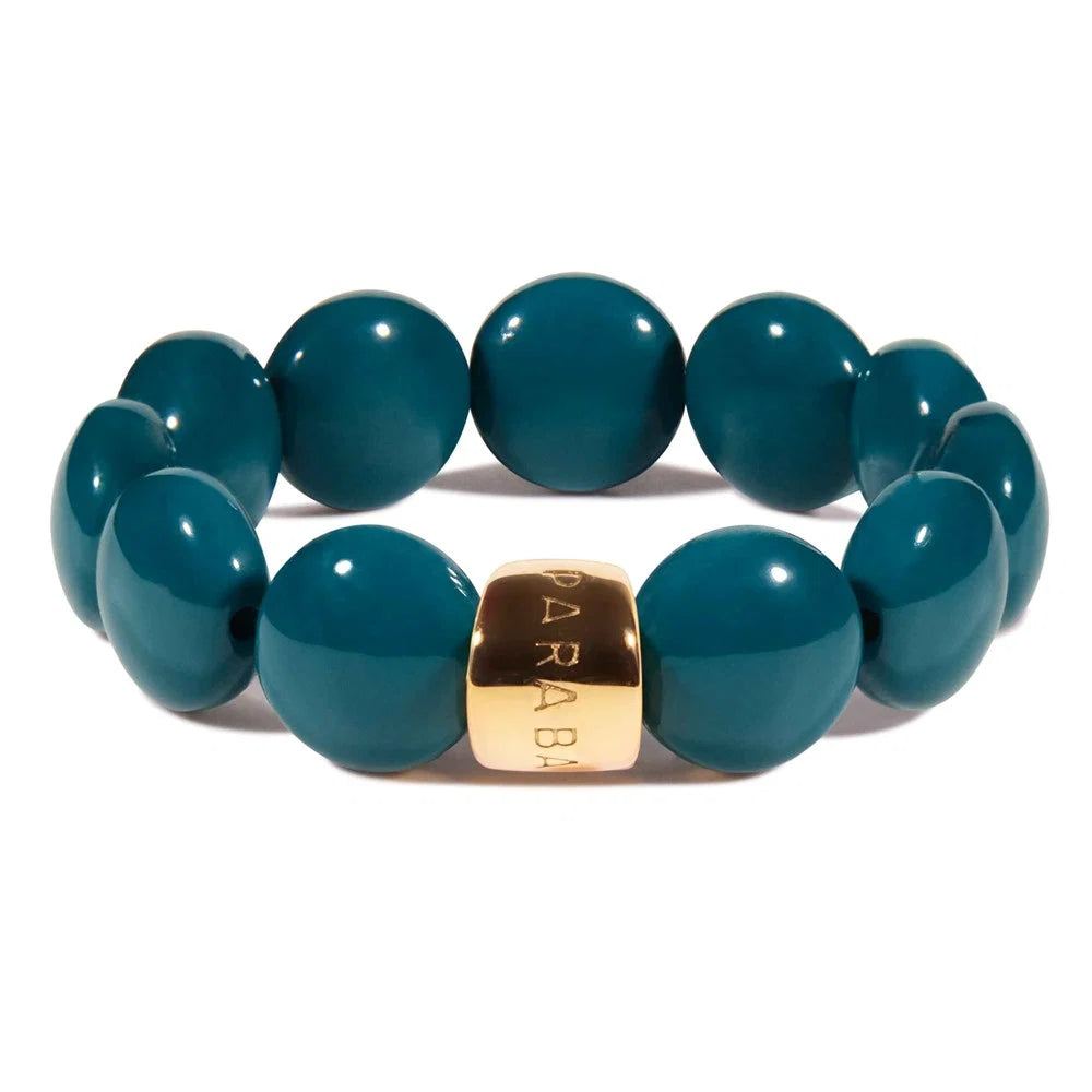 Teal beaded bracelet with a gold accent on a white background