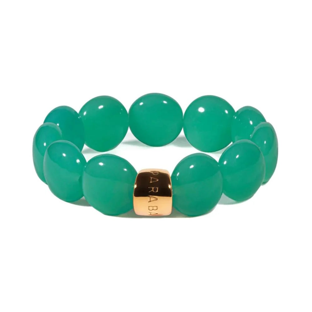 Green beaded bracelet with a gold tag on a white background