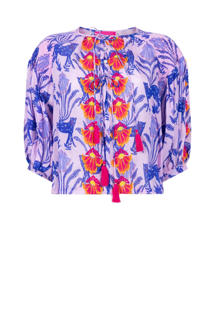 Colorful floral blouse with tassels on a white background