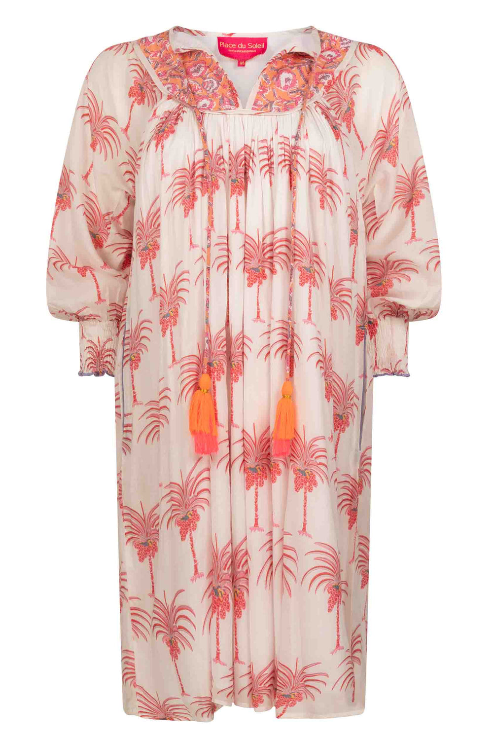 A white knee-length dress with a palm leaf pattern and three-quarter sleeves, displayed against a neutral background.