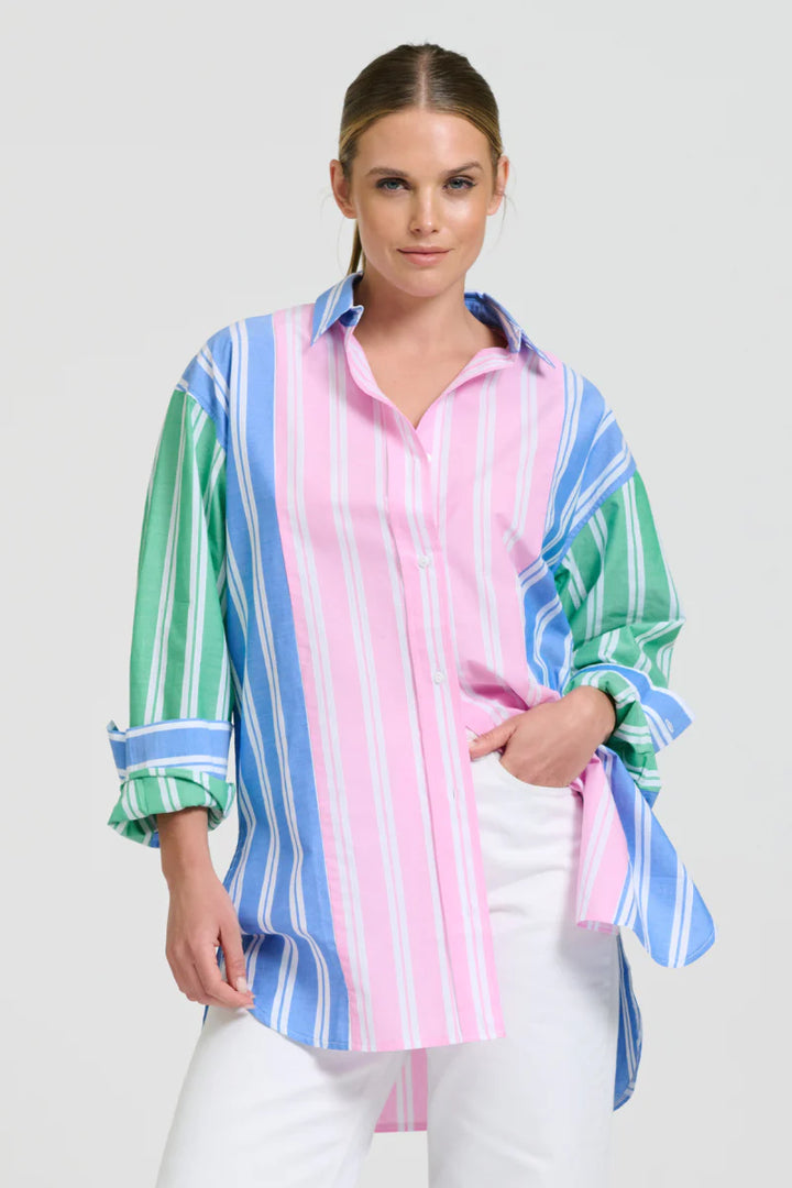 Woman wearing a colorful striped shirt with a white background