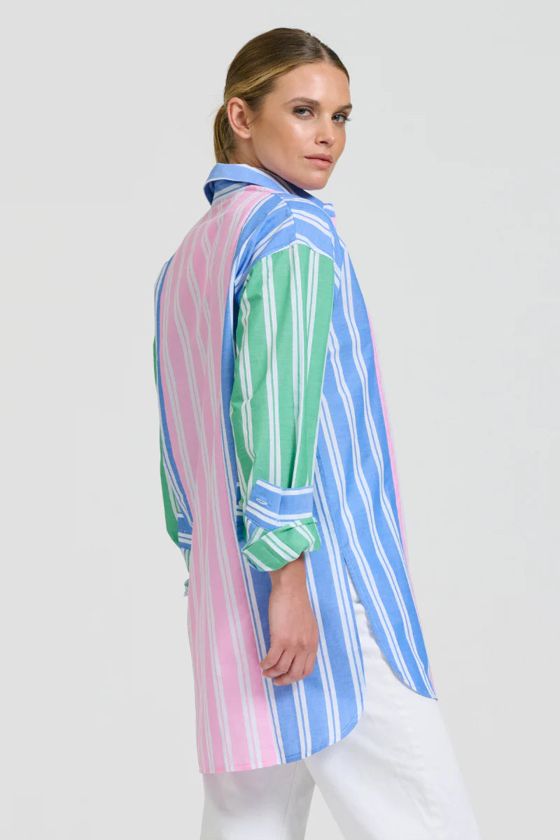 Woman wearing a colorful striped shirt on a white background