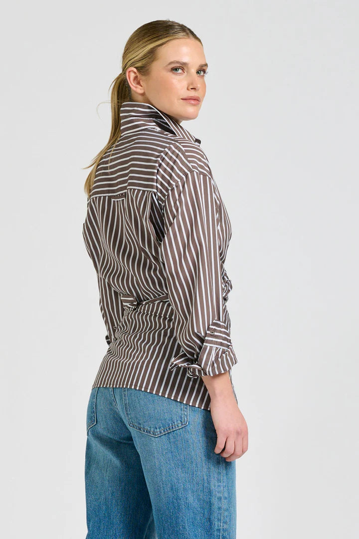 Woman wearing a striped shirt and jeans on a white background