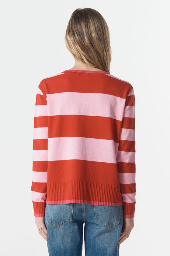 Person wearing a red and white striped sweater and blue jeans on a white background