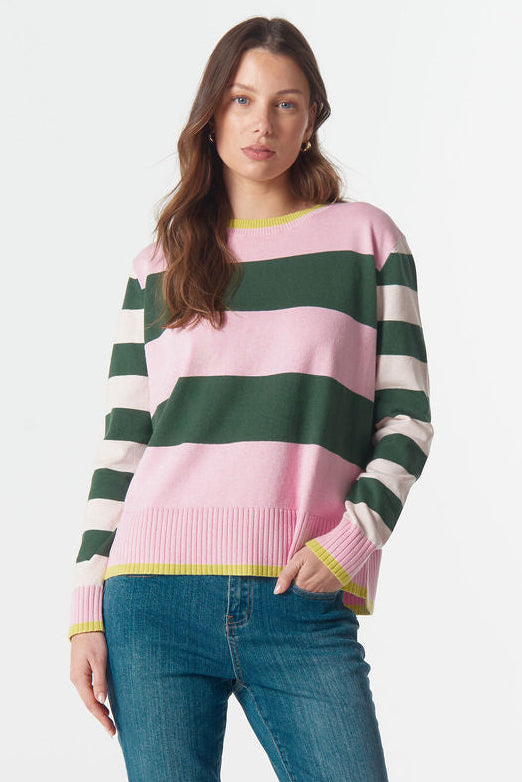 Woman wearing a striped sweater and jeans on a white background