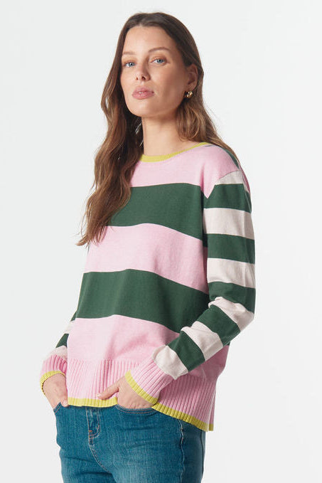 Woman wearing a striped sweater and jeans on a white background