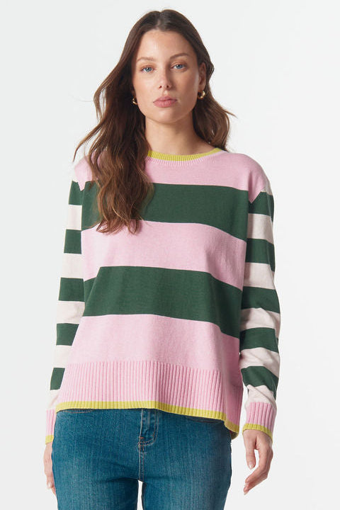 Woman wearing a striped sweater and jeans on a white background