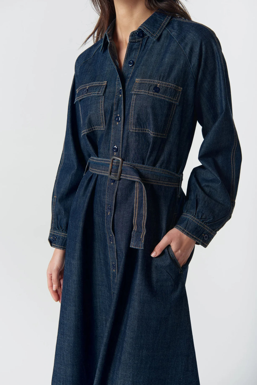 Denim dress worn by a person on a white background