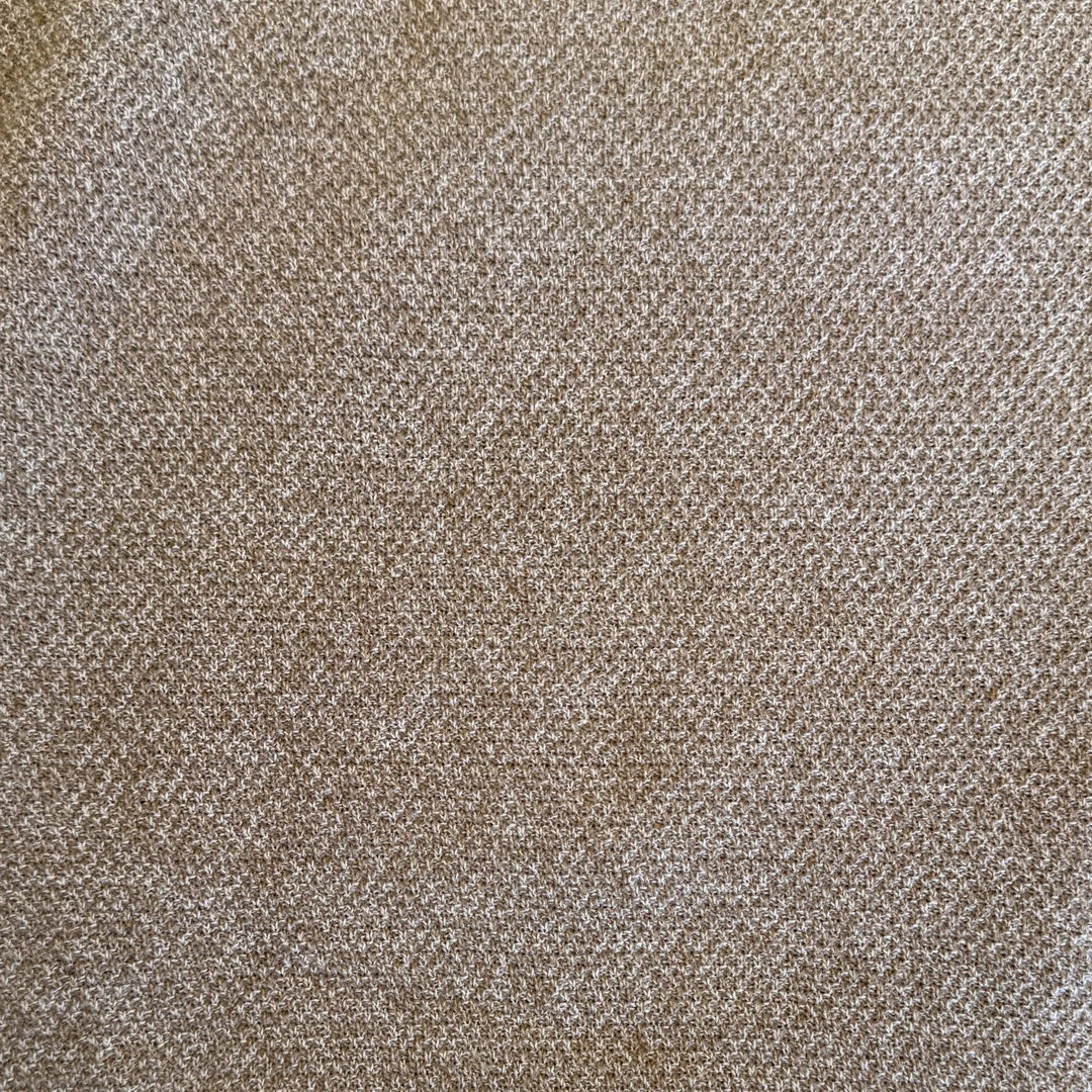 A close-up of a woven fabric texture in a warm taupe-brown color with subtle lighter beige highlights.
