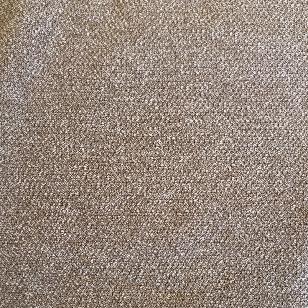 A close-up of a woven fabric texture in a warm taupe-brown color with subtle lighter beige highlights.