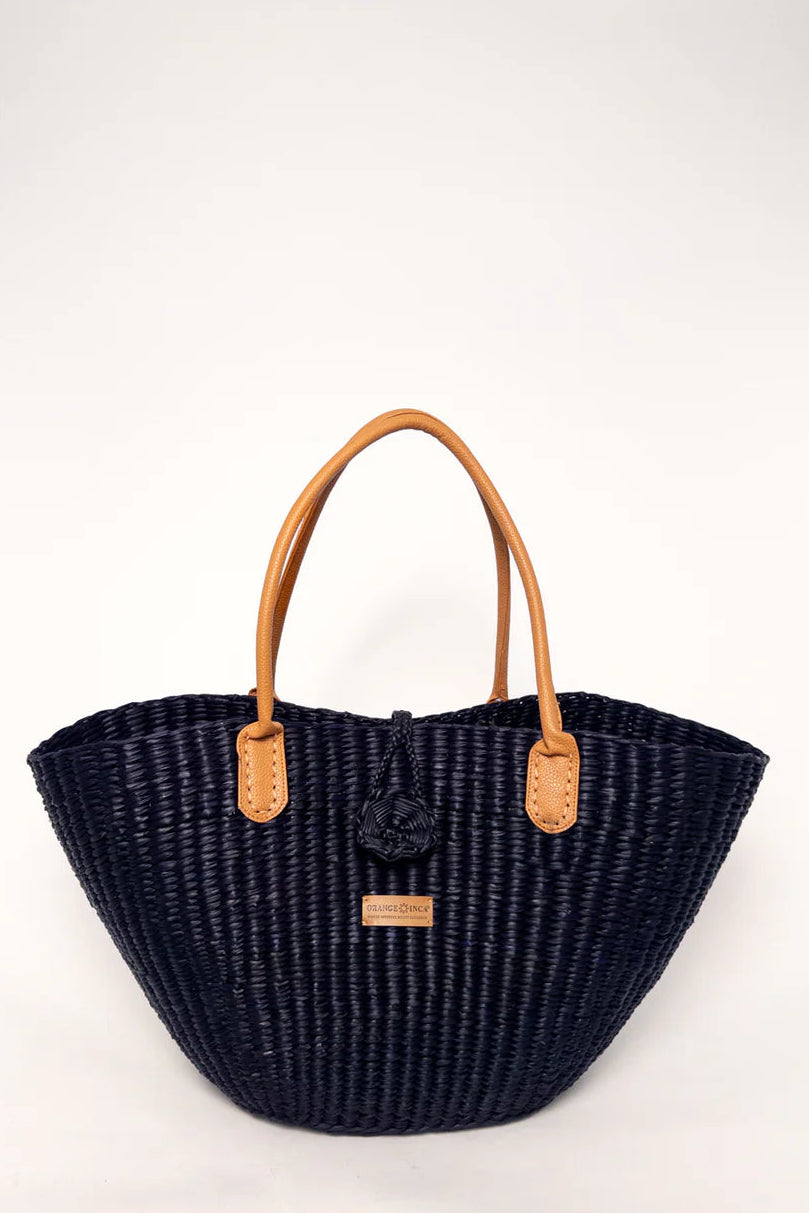 Black woven handbag with brown handles on a white background