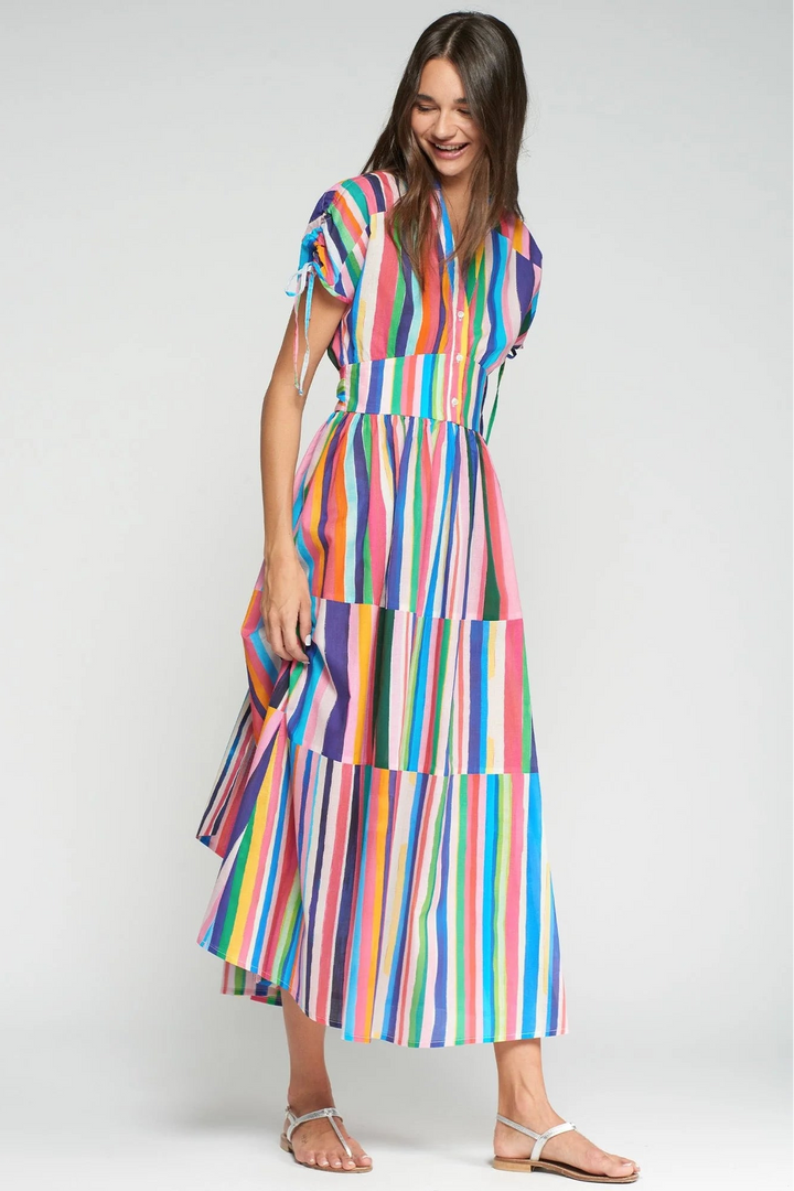 Woman wearing a colorful striped dress on a white background