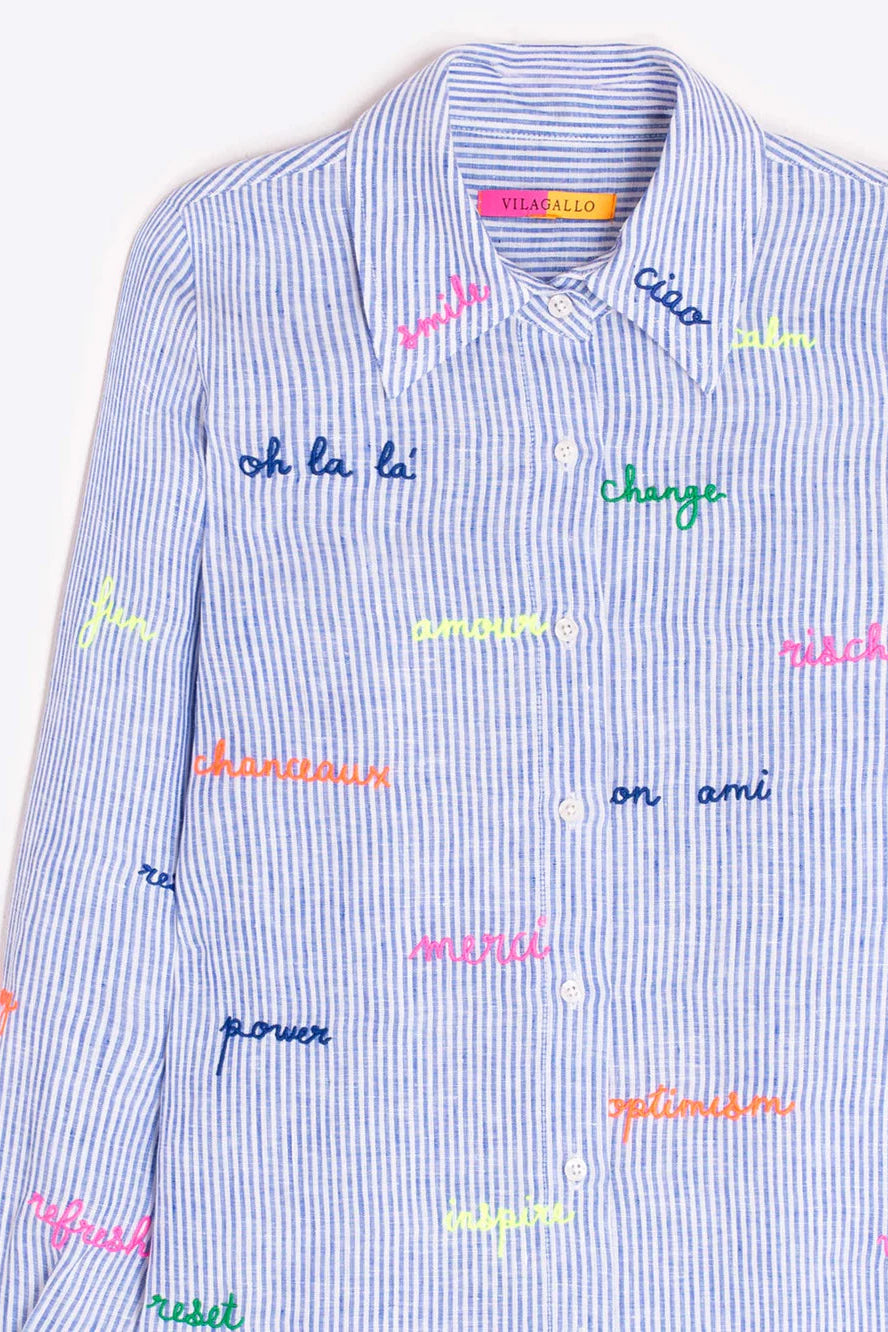 Blue striped shirt with colorful text patterns on a white background