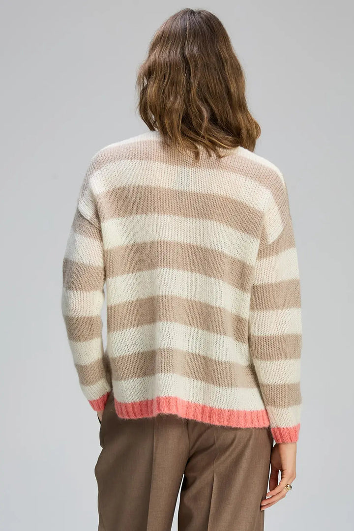 Person wearing a striped sweater with a neutral background