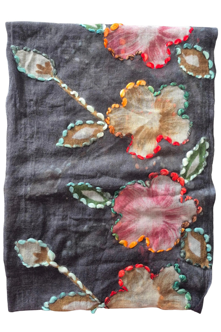 Floral embroidered fabric on a gray background