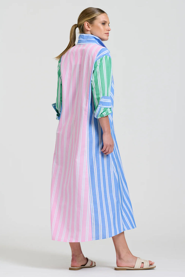 Woman wearing a colorful striped dress on a white background