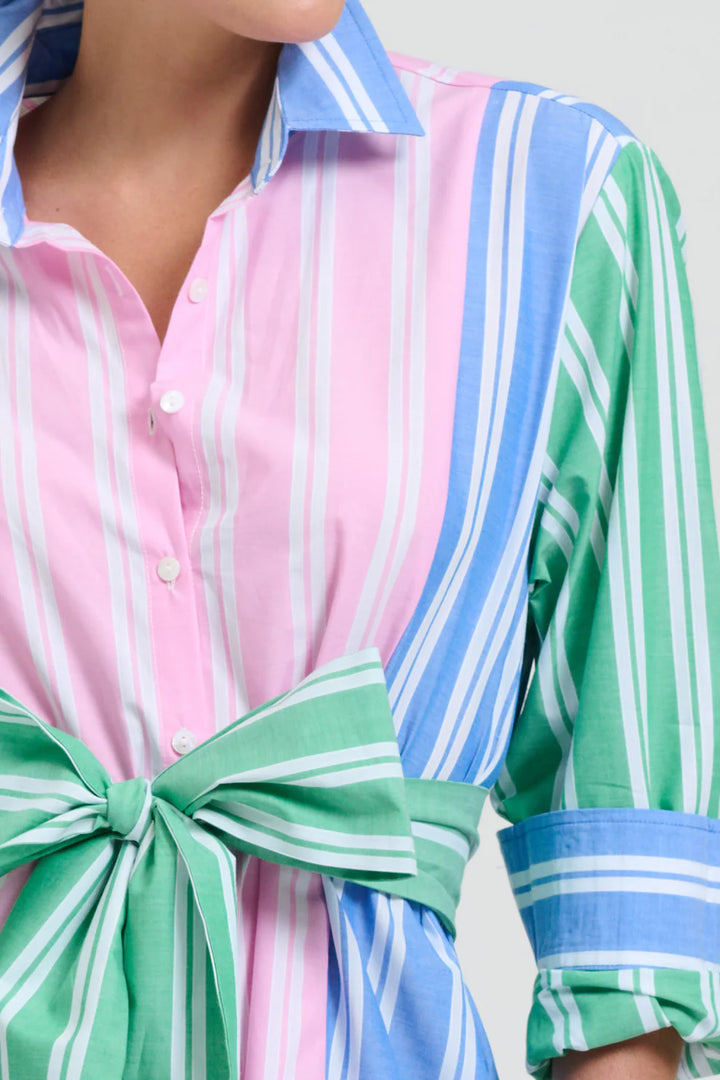 Close-up of a person wearing a colorful striped shirt with a green bow tie.